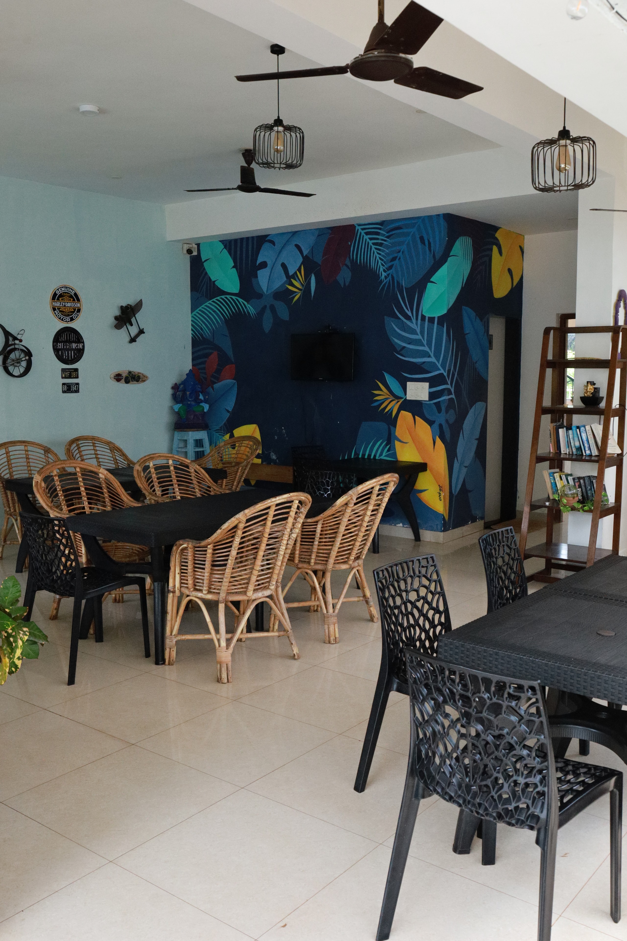 Anjuna Abode 1 — rattan dining chairs with tropical mural