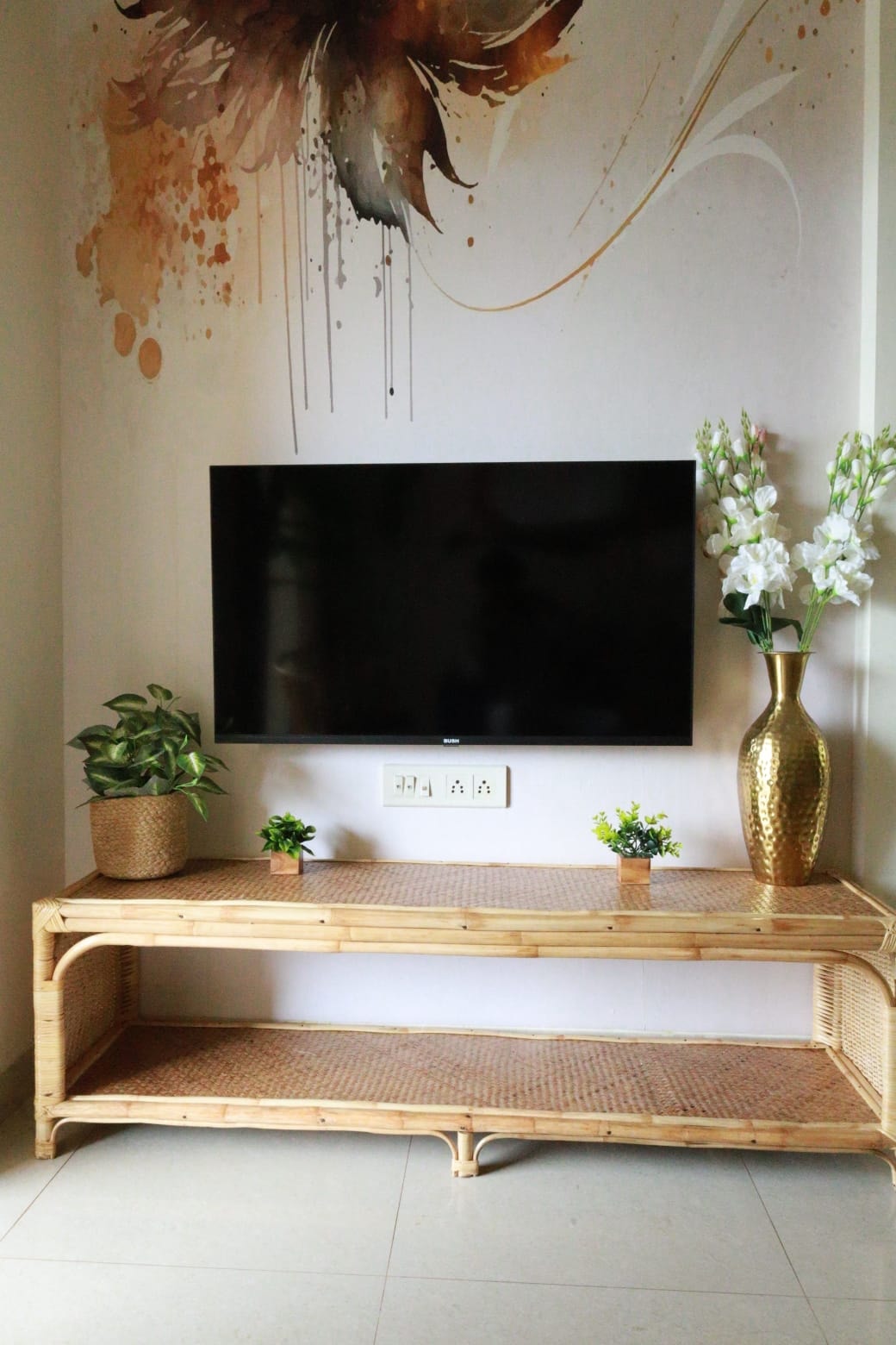 Anjuna Abode 2 — rattan TV unit with watercolour wall mural